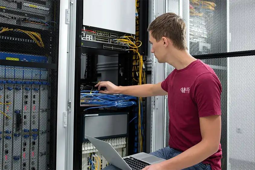 IT worker maintaining a server rack