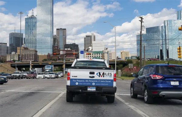 Miles IT truck driving through a commercial hub